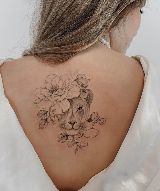 Lioness with flowers tattooed on the back