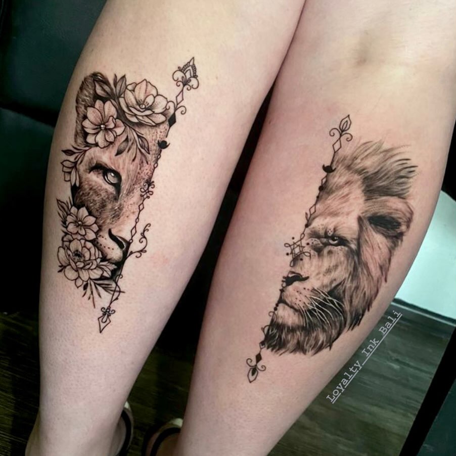 Lion and lioness with flowers tattooed on the calf