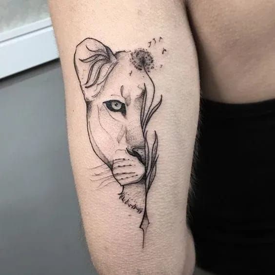 Lioness and dandelion tattoo on the arm