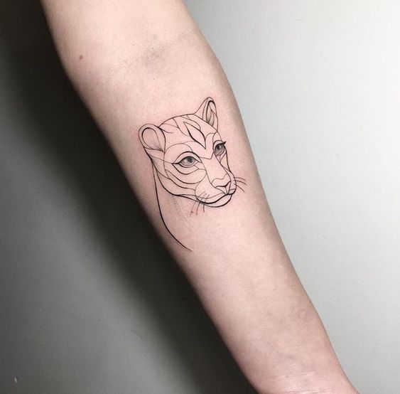 Fine line style lioness tattoo on the inner forearm