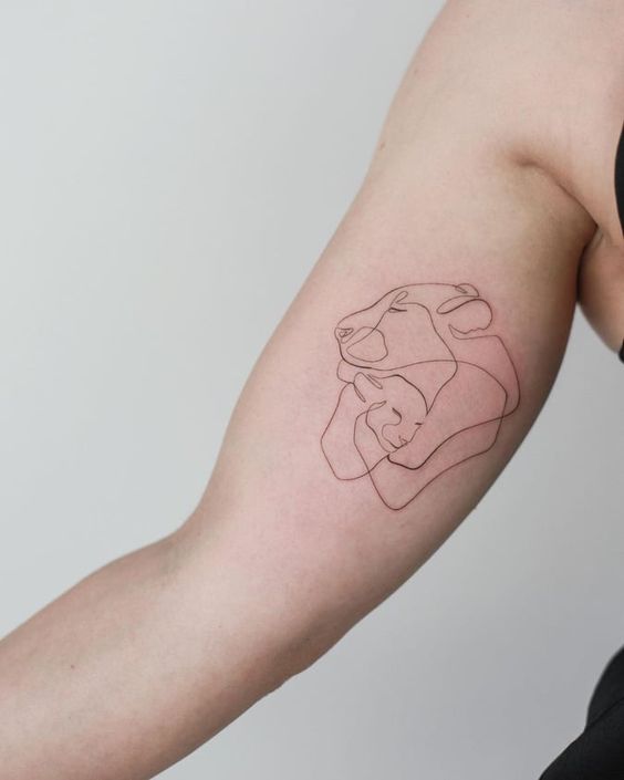 Single line lioness and cub tattoo on the inner arm