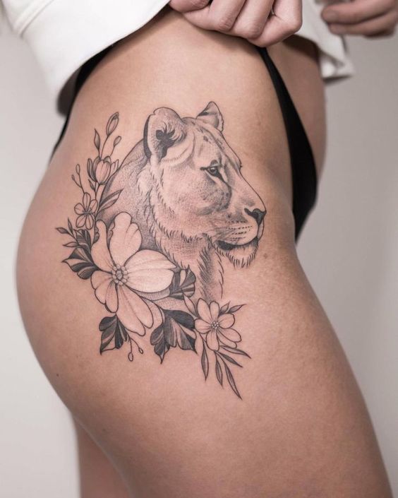 Lioness and flowers tattoo on the hip