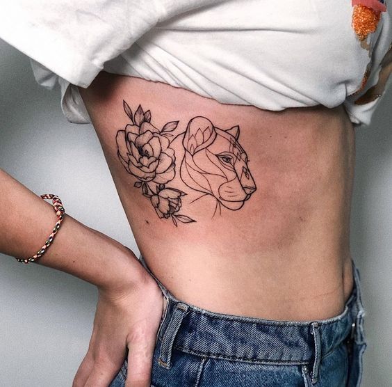 Fine line style lioness and flowers tattoo on the ribs