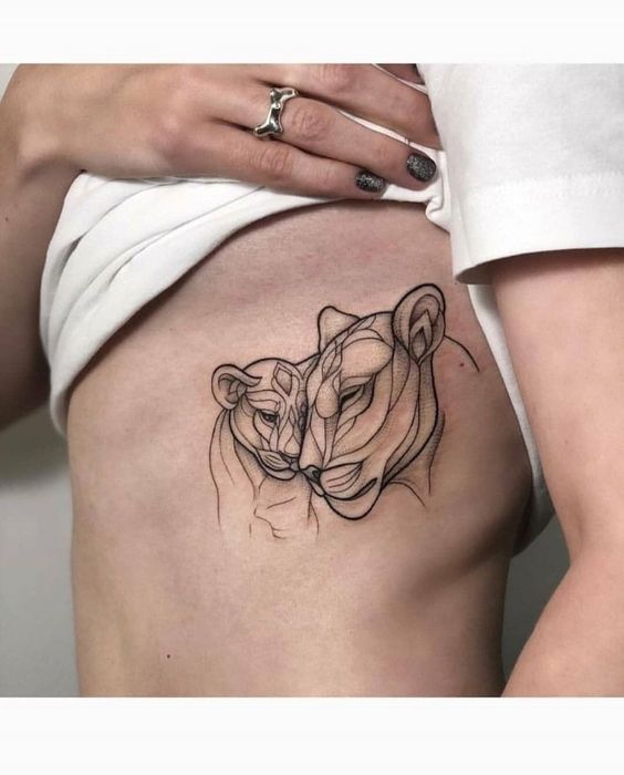 Fine line style lioness and lion cub tattoo on the ribs