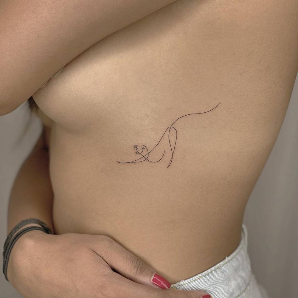 Single line lioness tattoo on the ribs