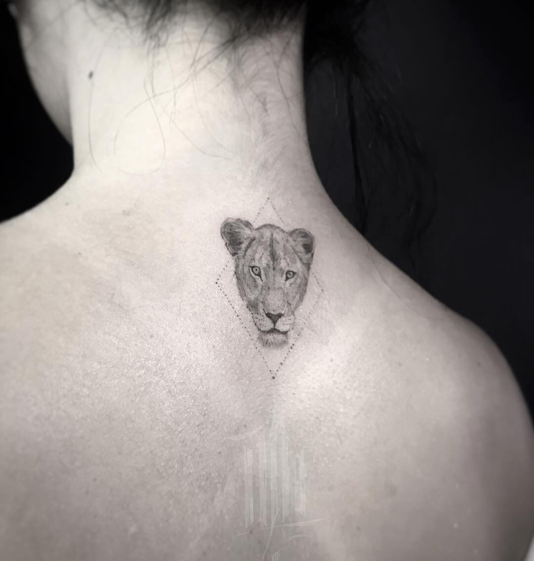 Micro-realistic style lioness portrait tattoo on the upper back