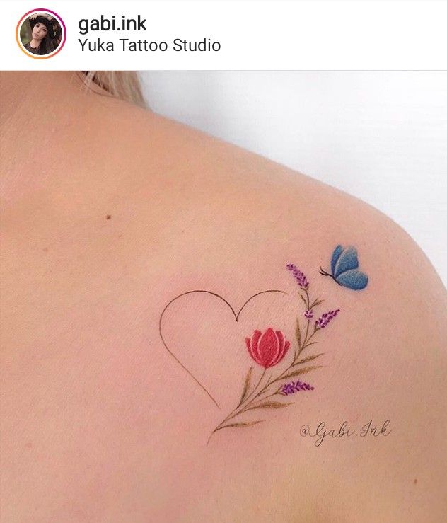 This may contain: the back of a woman's shoulder with flowers and butterflies on her left side