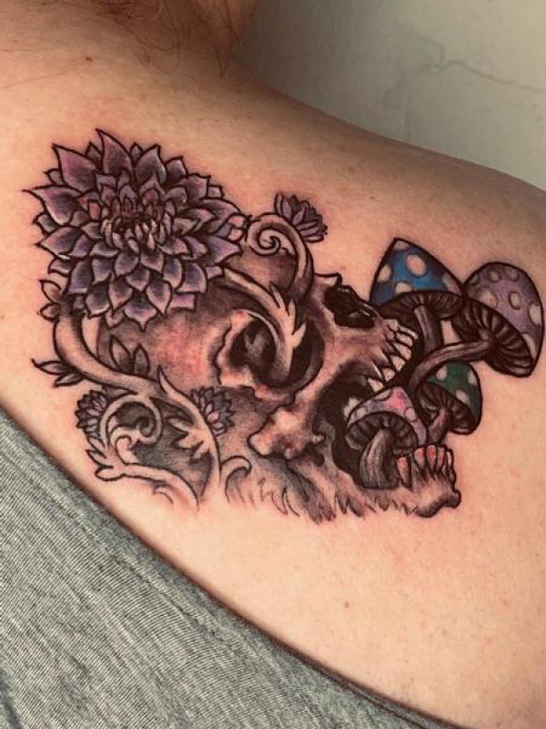 Skull with dahlia and mushroom tattoo