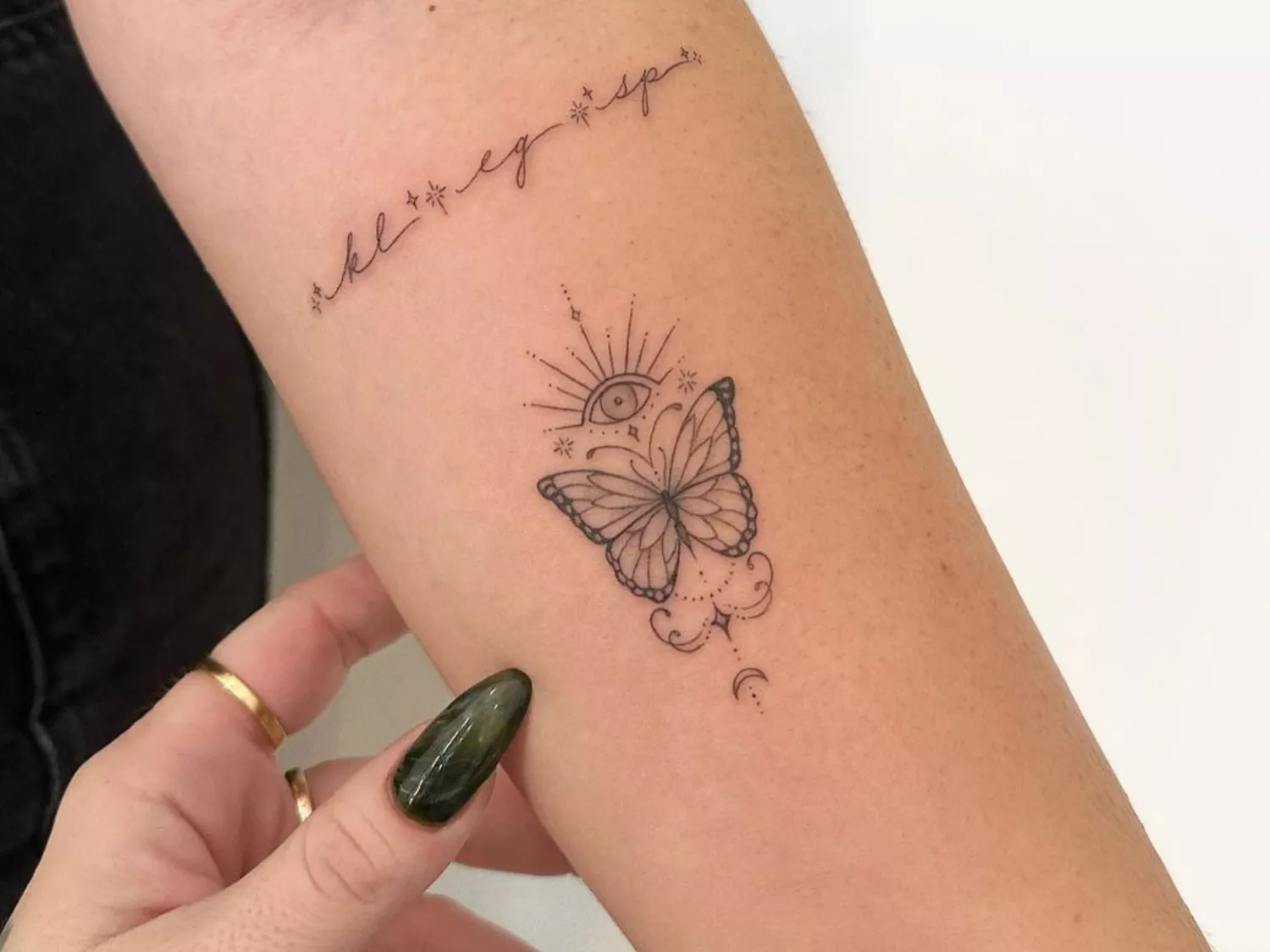 Close up of an arm with a butterfly tattoo