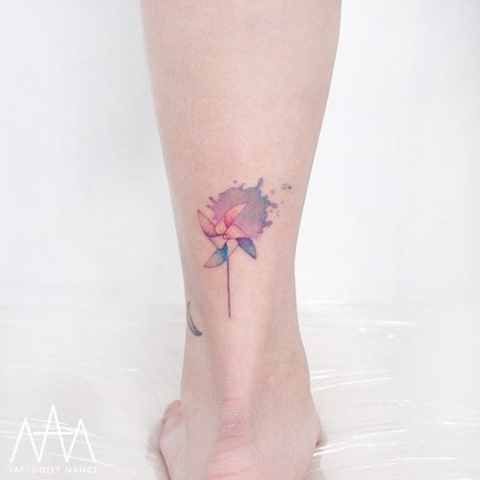 Watercolor Pinwheel Tattoo on Leg by Tattooist Nanci