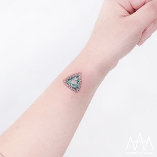 Emerald Tattoo on Wrist by Tattooist Nanci