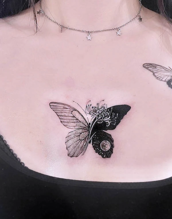 Black and white butterfly chest tattoo by @xen_tattooist