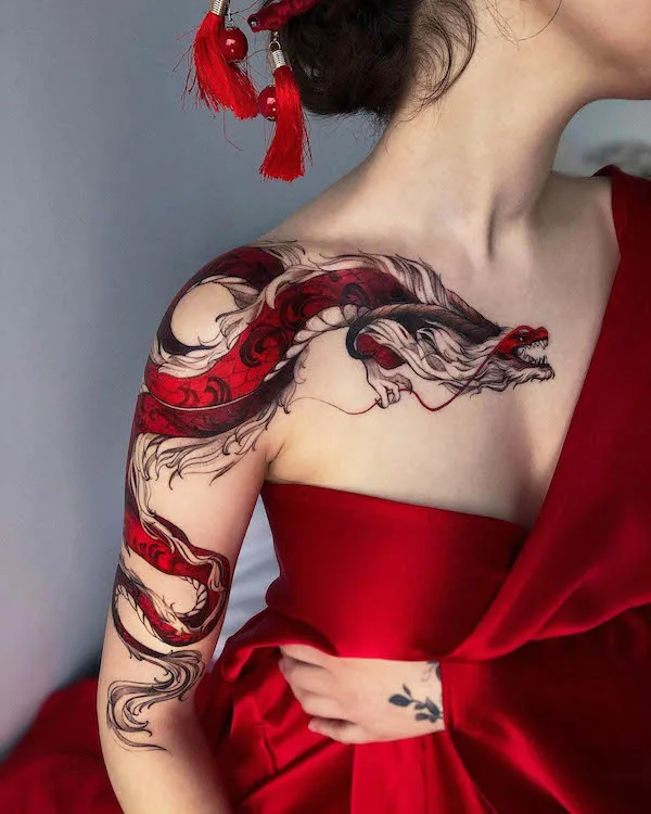 Fascinating red dragon chest and sleeve tattoo by @tattoo__marka