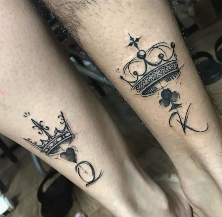 This may contain: two people with tattoos on their legs and one is wearing a tiara, while the other has a shamrock