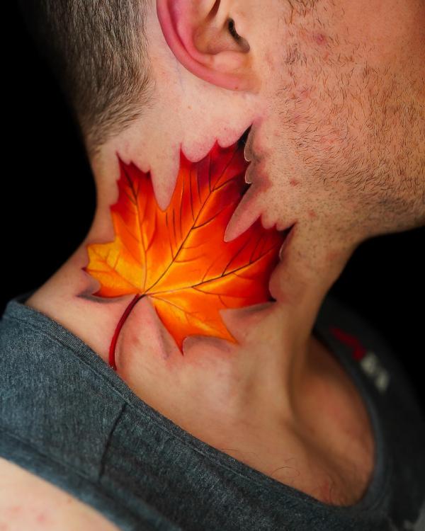 Vibrant maple leaf neck tattoo