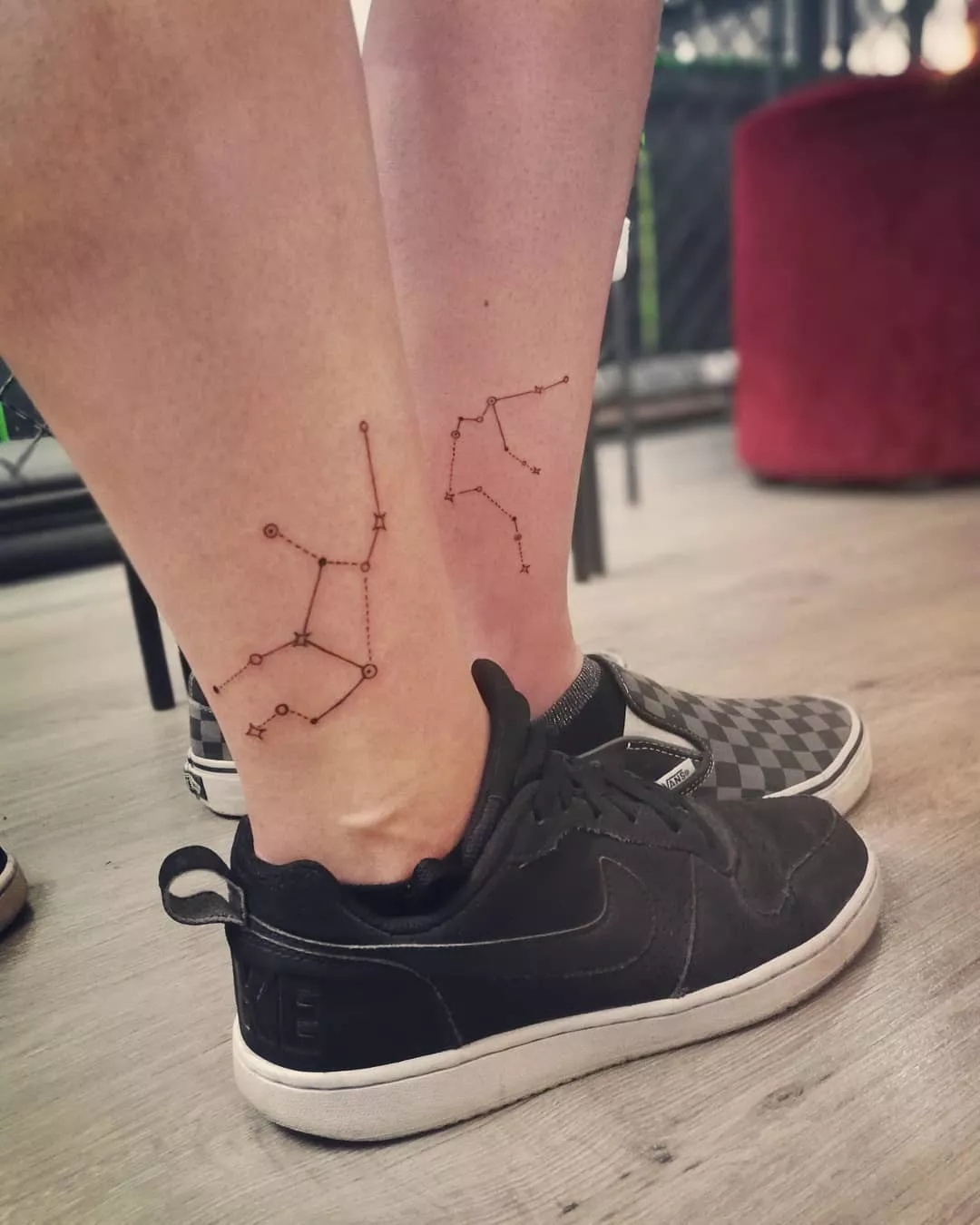 Close up of two ankles with matching constellation tattoos