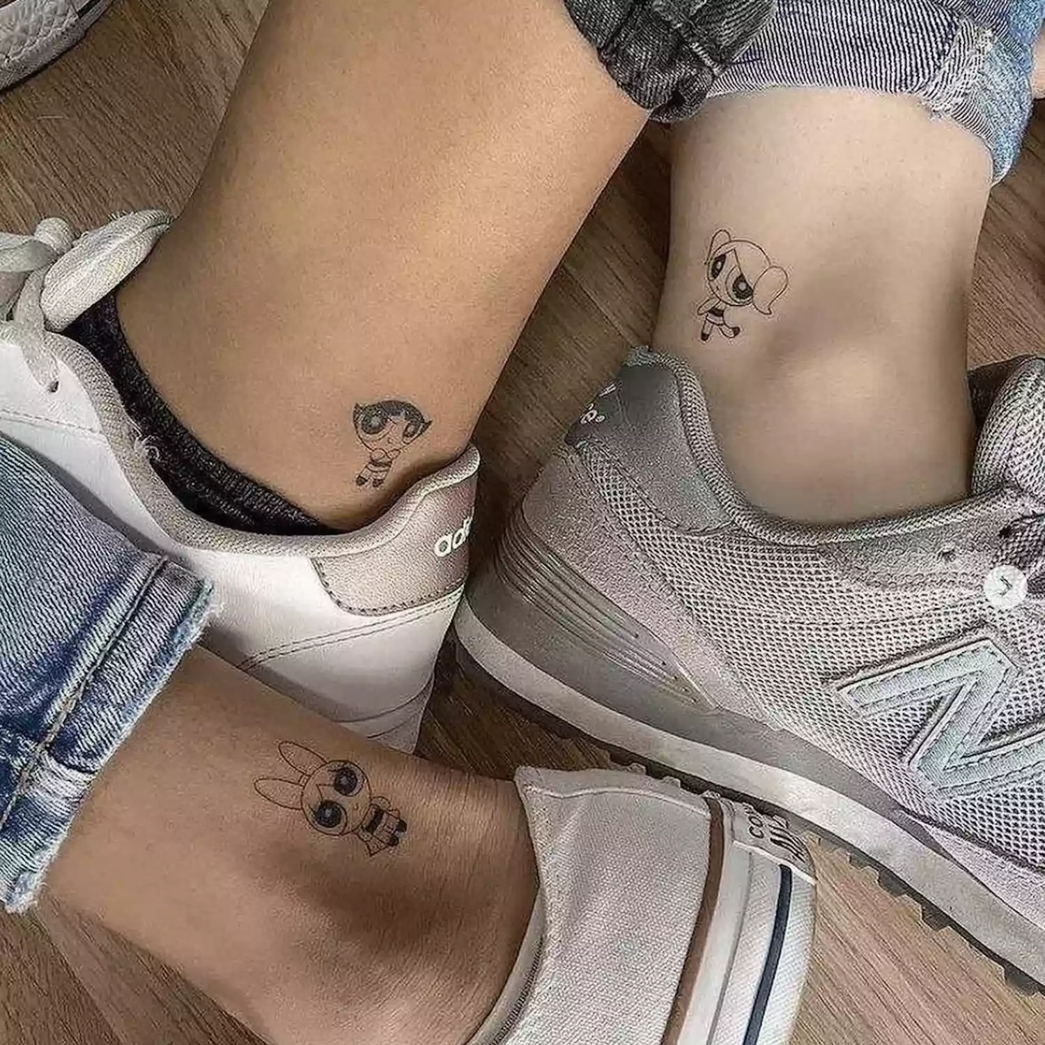 Three friends with matching Powerpuff Girl tattoos on ankles